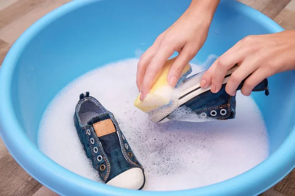 Woman washing sneakers — Stock Photo, Image