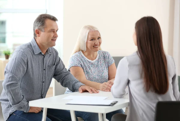 Female insurance agent consulting senior couple in office — Stock Photo, Image