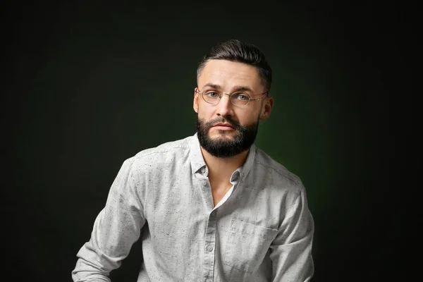 Portrait of handsome young hipster man on dark background — Stock Photo, Image