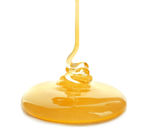 Sweet honey pouring on white background