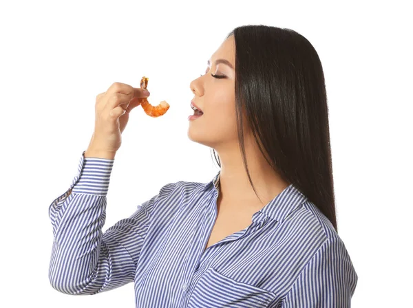 Beautiful Asian woman eating shrimp on white background — Stock Photo, Image