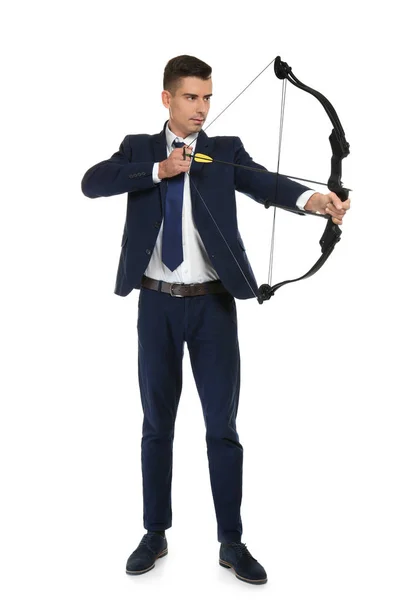 Young businessman practicing archery on white background — Stock Photo, Image