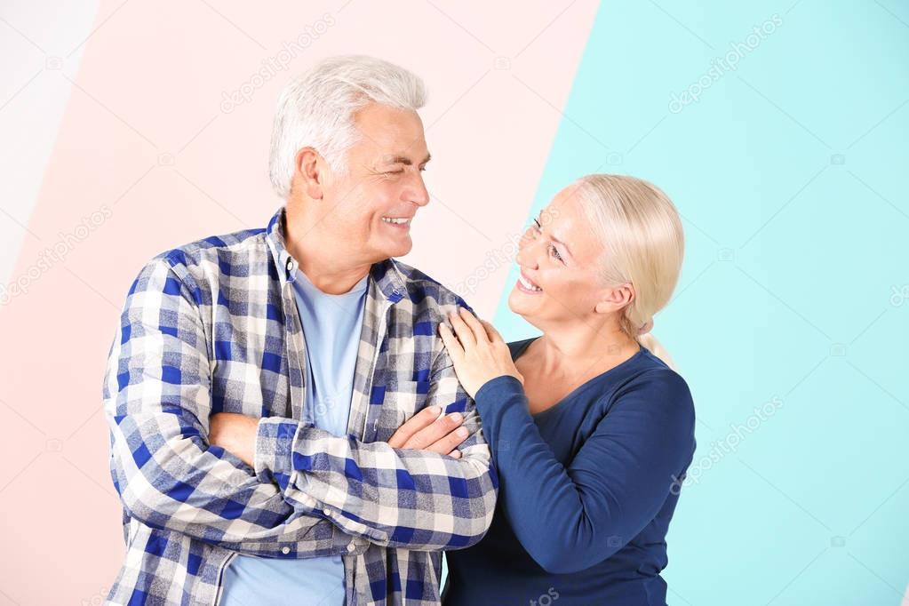 Mature couple against color background