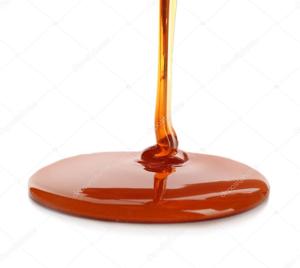 Sweet honey pouring on white background