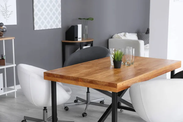 Modern office interior with wooden table and armchairs — Stock Photo, Image