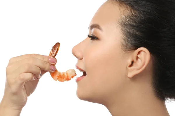 Beautiful Asian woman eating shrimp on white background — Stock Photo, Image