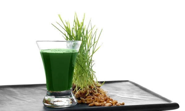 Tray with shot of healthy juice and sprouted wheat grass on white background — Stock Photo, Image