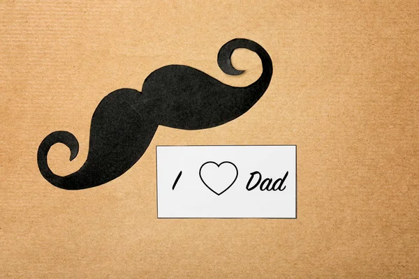 Composition with phrase I LOVE DAD for Father's Day on craft paper — Stock Photo, Image