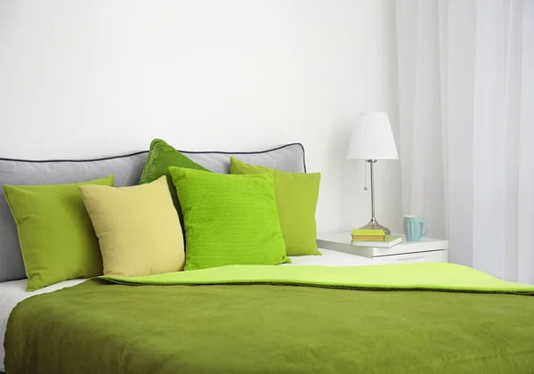 Comfortable bed with cushions in room — Stock Photo, Image