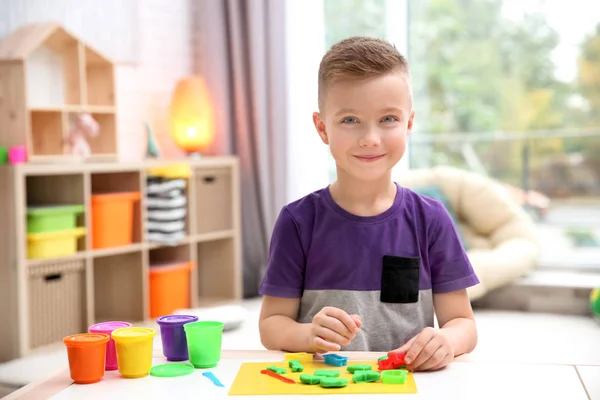 Niño pequeño dedicado al modelado de plastilina en la guardería — Foto de Stock