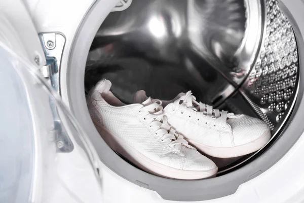 Pair of white sneakers in washing machine, closeup — Stock Photo, Image