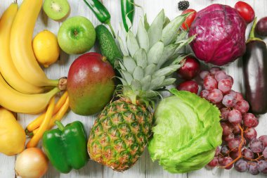 Meyve ve sebze gökkuşağı renkleri, düz ahşap arka plan üzerinde yapılmış yaratıcı kompozisyon yatıyordu