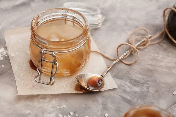 Empty caramel jar on table — Stock Photo, Image