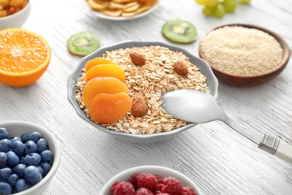 Bowl with oatmeal flakes — Stock Photo, Image