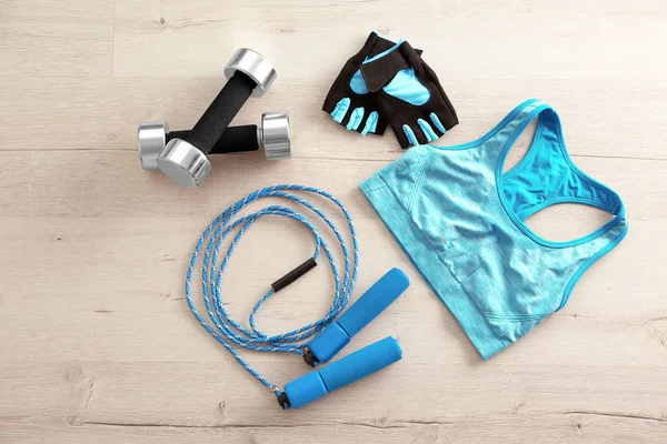 Jumping rope, sport top, dumbbells and gloves — Stock Photo, Image