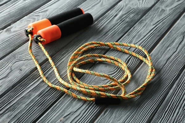 Jumping rope on wooden background — Stock Photo, Image