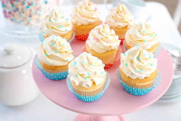 Stand with delicious cupcakes — Stock Photo, Image