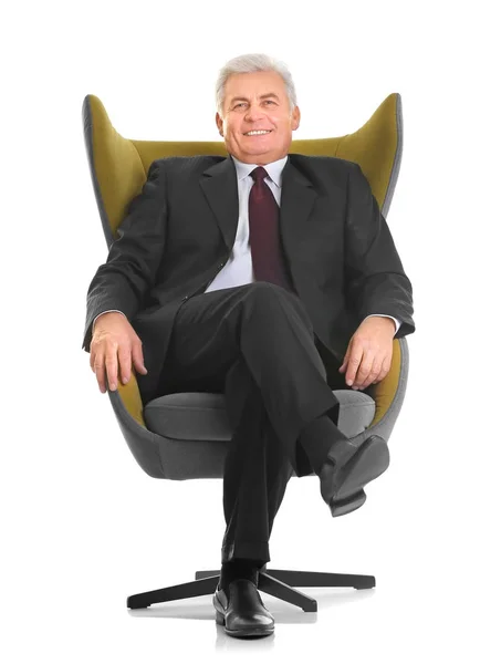 Mature man sitting in armchair — Stock Photo, Image