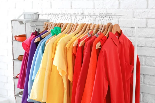 Rack with rainbow clothes — Stock Photo, Image