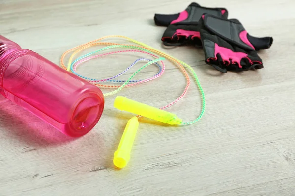 Jumping rope, gloves and plastic bottle — Stock Photo, Image