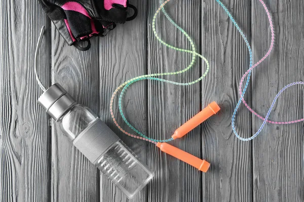 Jumping rope, bottle and gloves