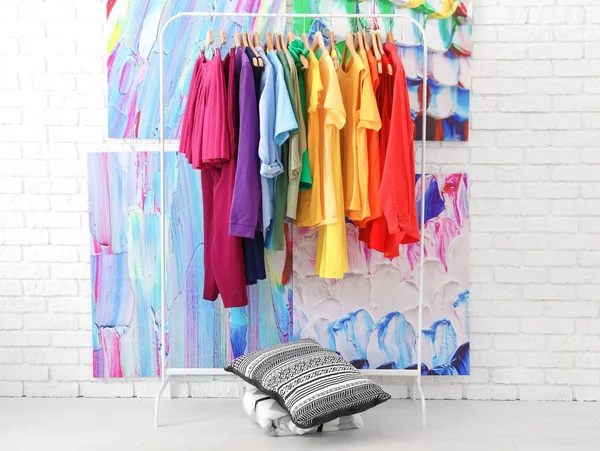 Rack with rainbow clothes — Stock Photo, Image