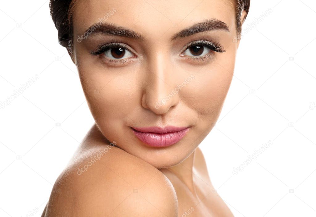 Portrait of beautiful young woman with eyelash extensions on white background