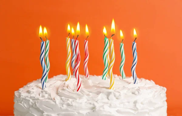 Birthday cake with candles on color background, closeup — Stock Photo, Image