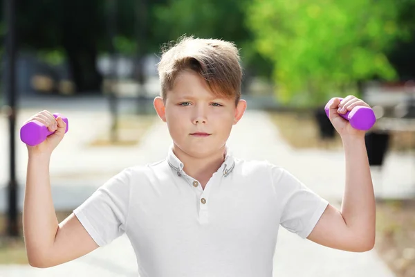 Overgewicht jongen met halters opleiding in park — Stockfoto