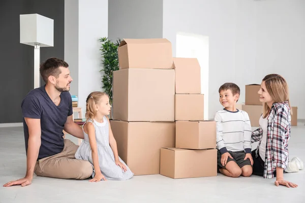 Happy family with cardboard boxes in new flat — Stock Photo, Image
