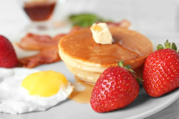 Вкусный завтрак с блинами и яичницей на столе — стоковое фото