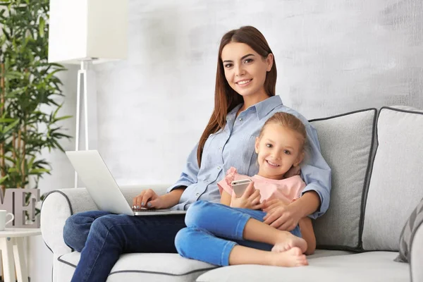 Busy young woman with daughter in home office — Stock Photo, Image