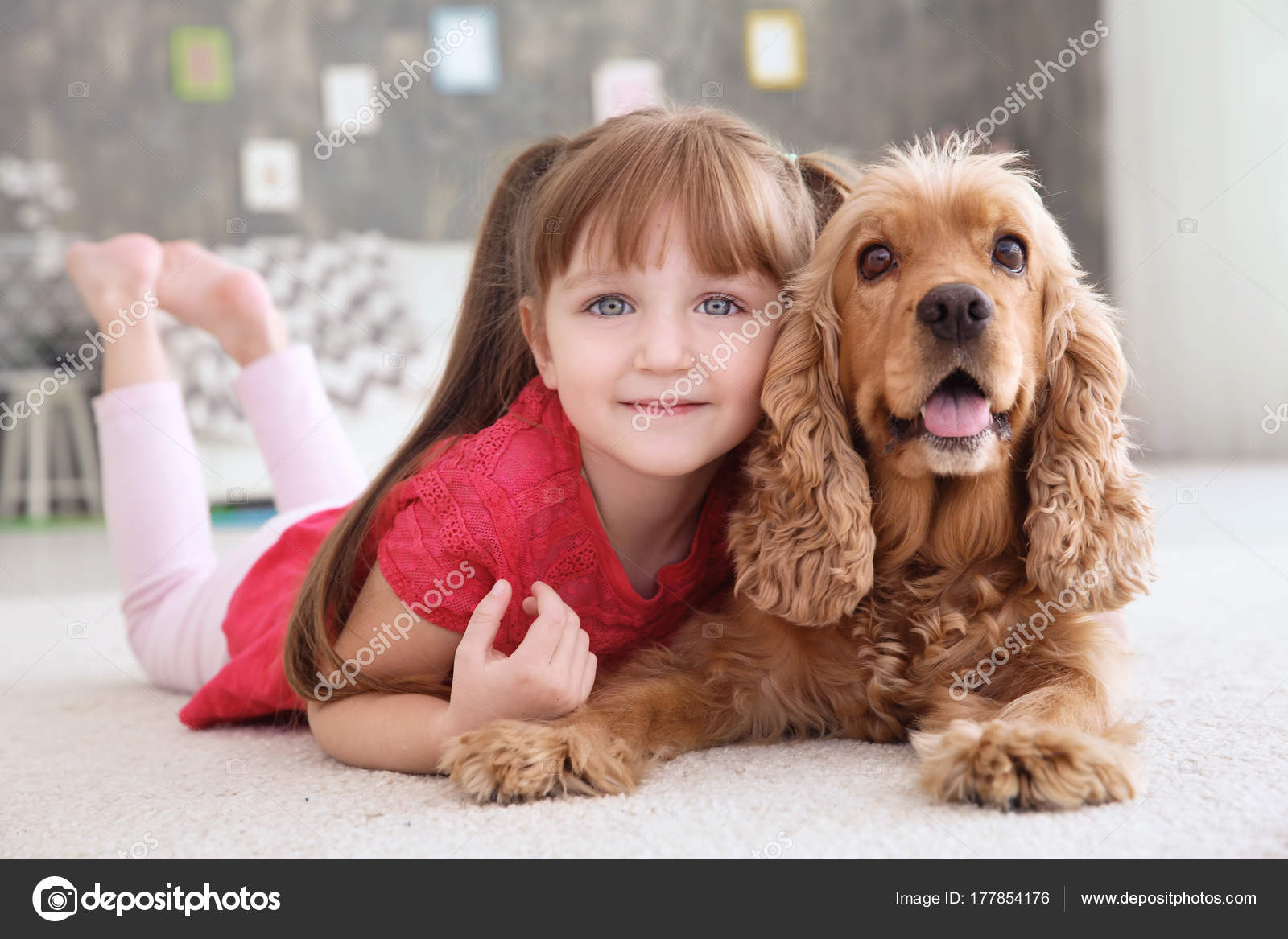 Cute little girl with dog at home Stock Photo by belchonock 177854176
