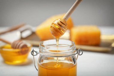 Ahşap Kepçe üzerinde arka plan bulanık, closeup kavanoza damlama tatlım