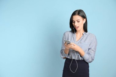 Cep telefonuyla müzik dinleyen güzel bir genç kadın.