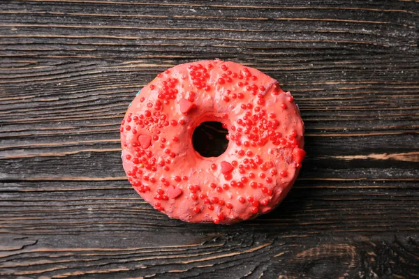 Tasty donut on wooden table — Stock Photo, Image