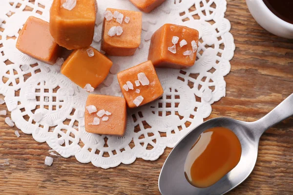 Tasty Caramel Candies Salt Wooden Table — Stock Photo, Image