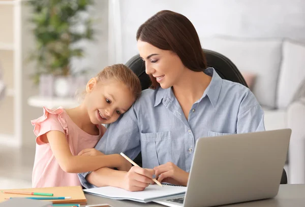 Busy young woman with daughter in home office — Stock Photo, Image