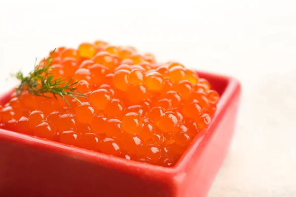 Tigela com delicioso caviar vermelho no fundo claro, close-up — Fotografia de Stock
