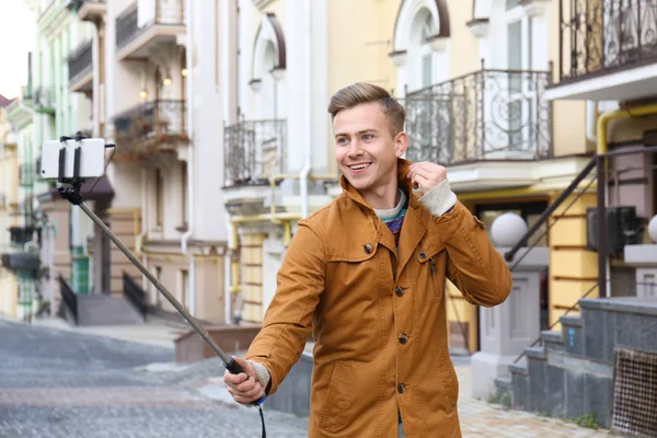 Jovem bonito homem tomando selfie ao ar livre — Fotografia de Stock