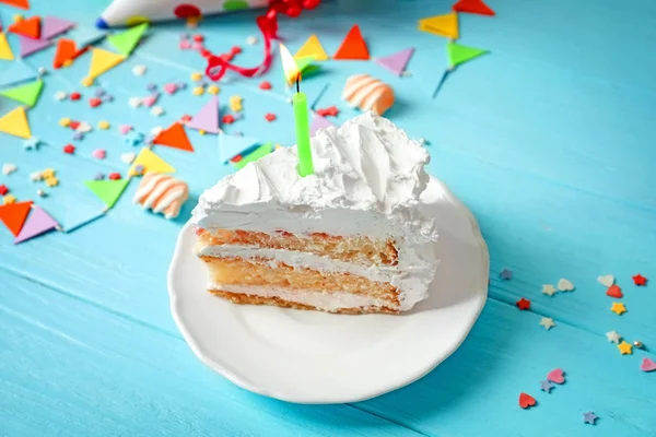 Pedaço de bolo de aniversário com vela na mesa — Fotografia de Stock