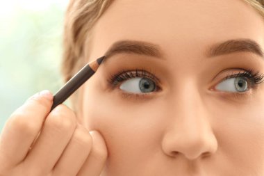 Güzellik salonunda kaş düzeltme ameliyatı olan genç bir kadın.