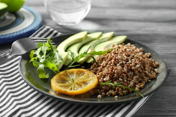 Plate Tasty Buckwheat Porridge Avocado Wooden Table Closeup — Stock Photo, Image