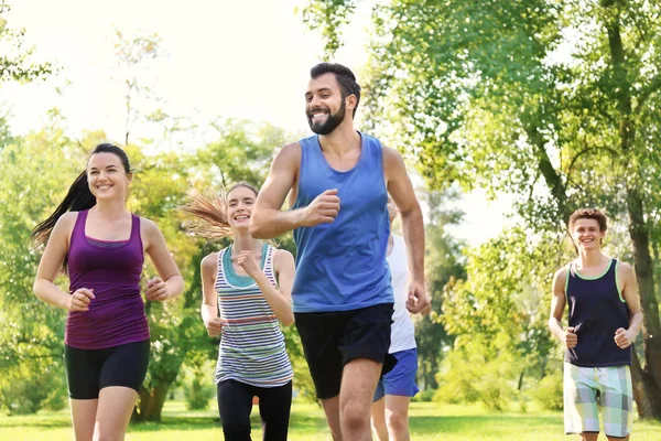 Group of young people running in park — Stock Photo, Image