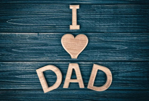 Greeting for Father's day with phrase "I love dad" made of letters on wooden background — Stock Photo, Image