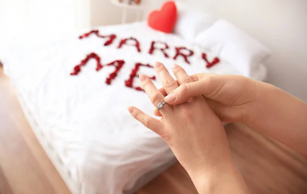 Woman accepting marriage proposal and wearing engagement ring in bedroom — Stock Photo, Image
