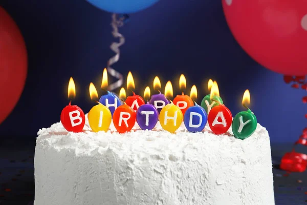 Torta con candele "Buon compleanno" su sfondo scuro, primo piano — Foto Stock