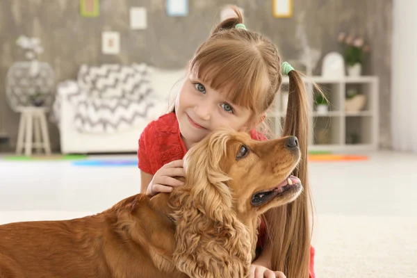 Schattig klein meisje met hond thuis — Stockfoto
