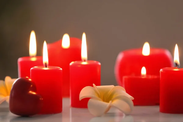 Burning red candles on table — Stock Photo, Image