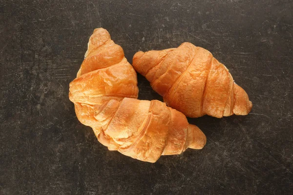 Delicious croissants on dark background — Stock Photo, Image